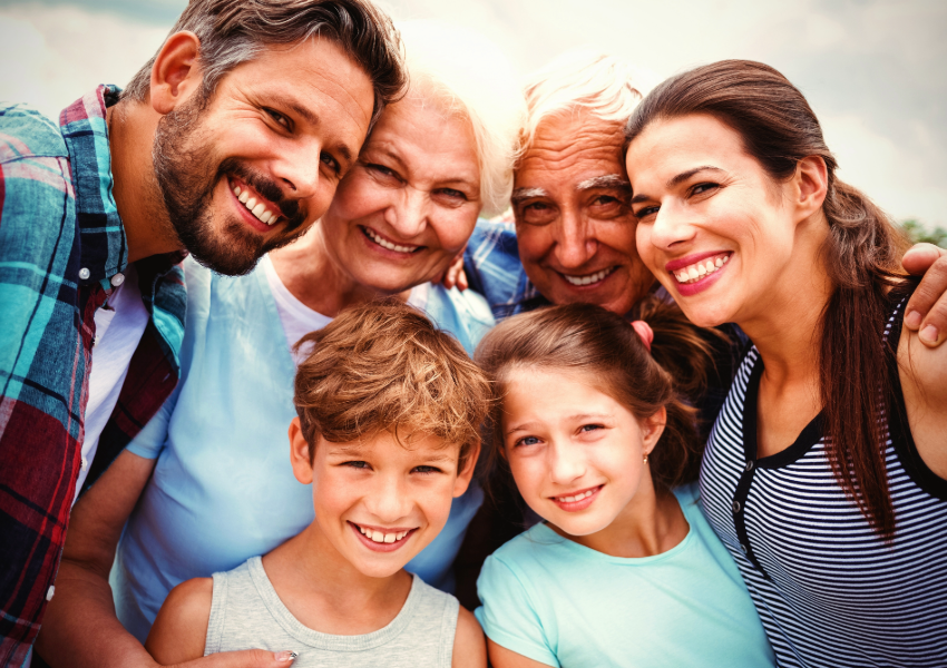 A multigenerational family enjoying a sunny day outdoors.