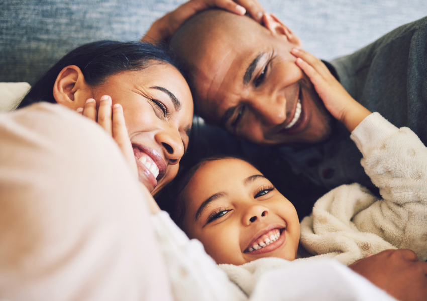 Happy family cuddling and smiling together.