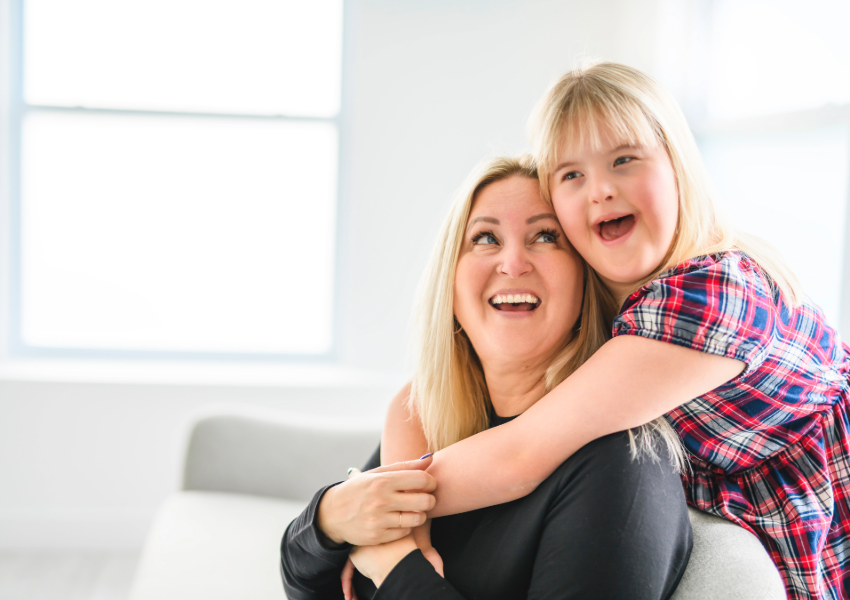 Mother and daughter sharing a joyful embrace.